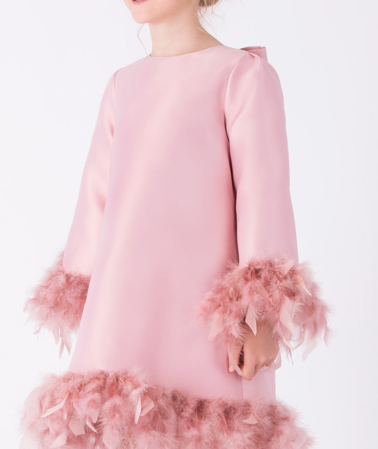 sleek pink dress that features playful feather trims at the hem and cuffs