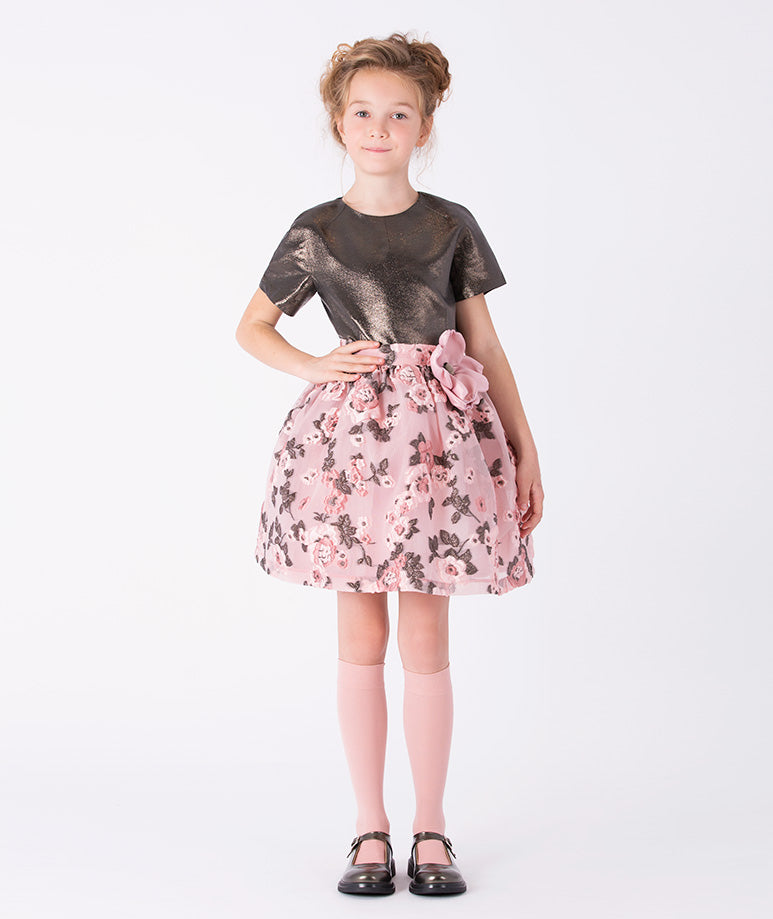 a gleaming metallic-textured bodice and a flowing floral skirt