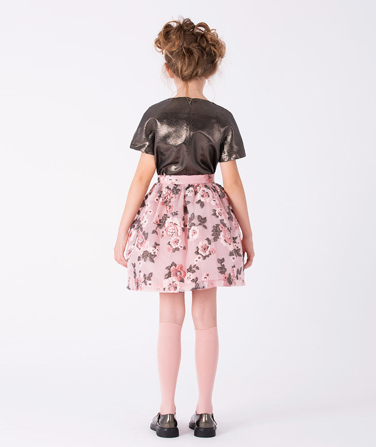 metallic-textured blouse and a floral skirt