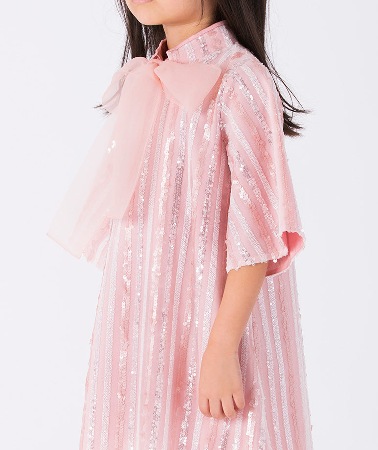 soft pink and white striped dress with airy wide sleeves, an organza bow and glitter