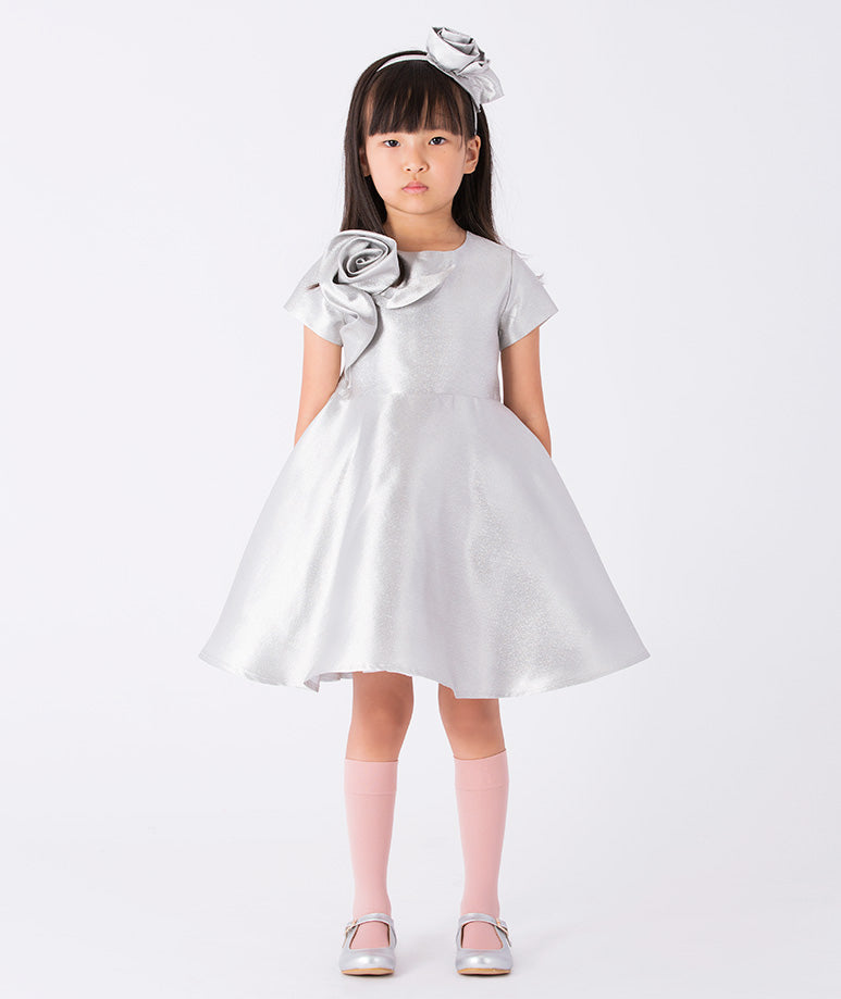 A sleek A-line silver dress with capped sleeves and a 3D rose on the side
