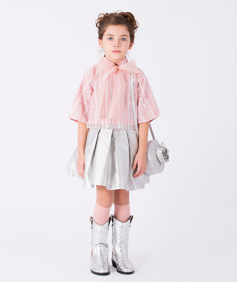 A lightweight glittery striped pink blouse with wide sleeves and a silver mini skirt