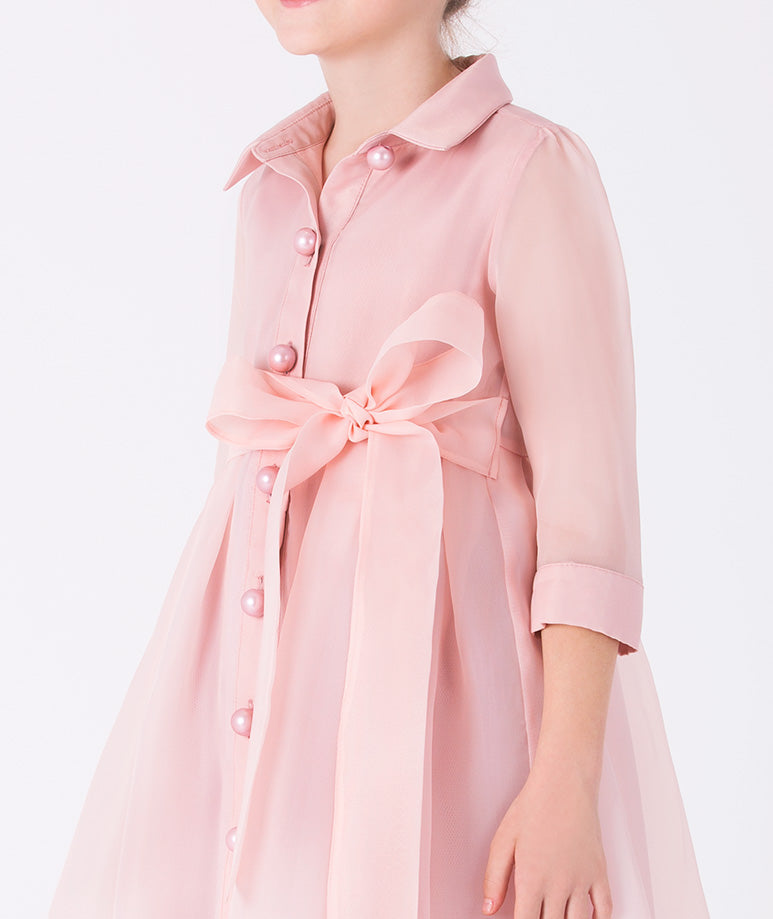 A polished shirt dress in a soft peach-pink hue