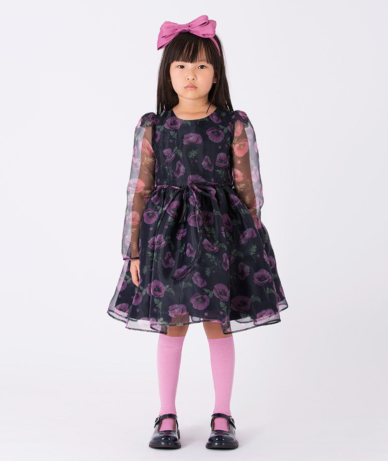 Floral-print dress with sheer organza sleeves, a layered skirt, and delicate ruffles. A magical dress designed to inspire twirls and spark imagination.