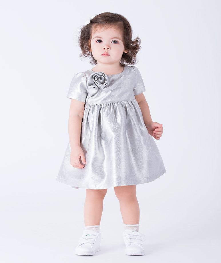An elegant silver baby dress with short sleeves and a 3D rose on the chest
