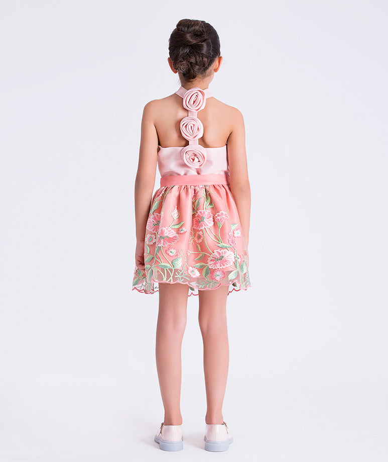 Back view of the Embroidered Floral Girls Outfit showing the halter neckline with floral rosette accents and softly layered embroidered skirt made from breathable lightweight fabric, designed for girls ages 3–12 for Eid, weddings, and garden parties.