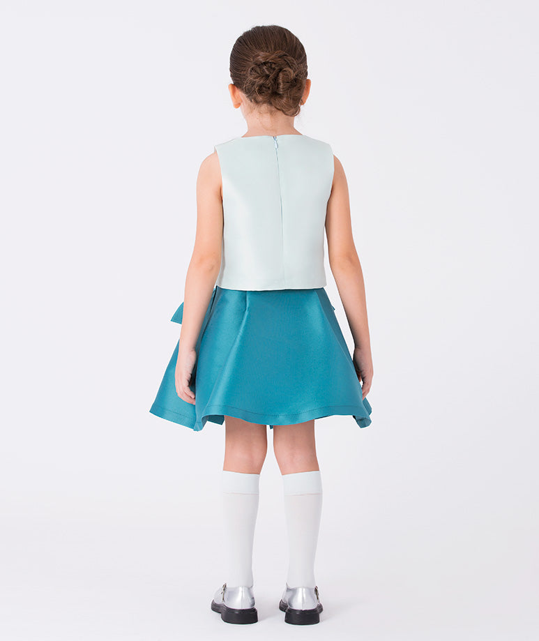 Back view of an ivory sleeveless girls blouse fully lined in cotton, designed for ceremonies and elegant gatherings (3–12y)