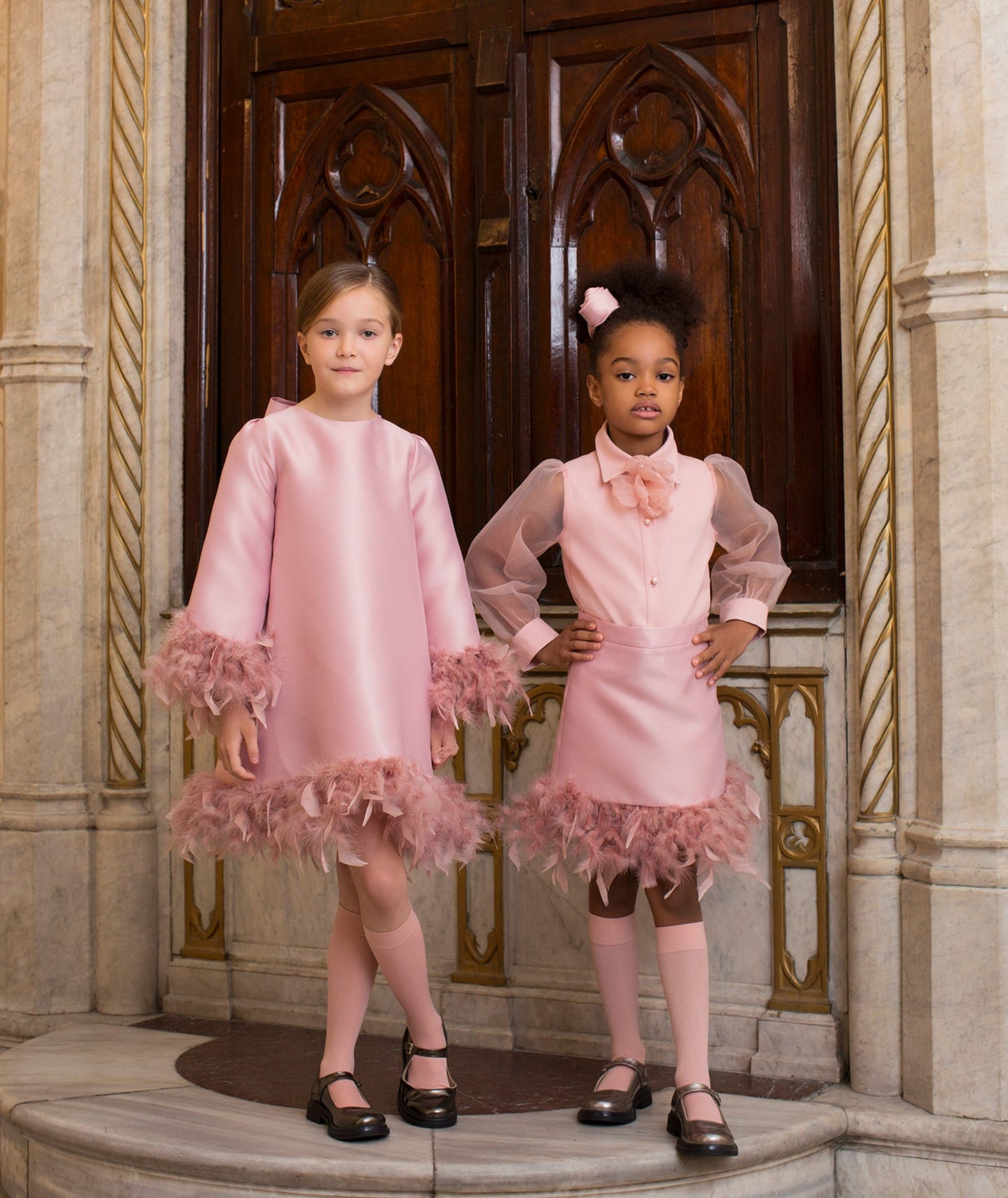 pink dress with feathery sleeves and hem, organza blouse with a 3D organza flower on the neckline and matching pink skirt with feathery hem