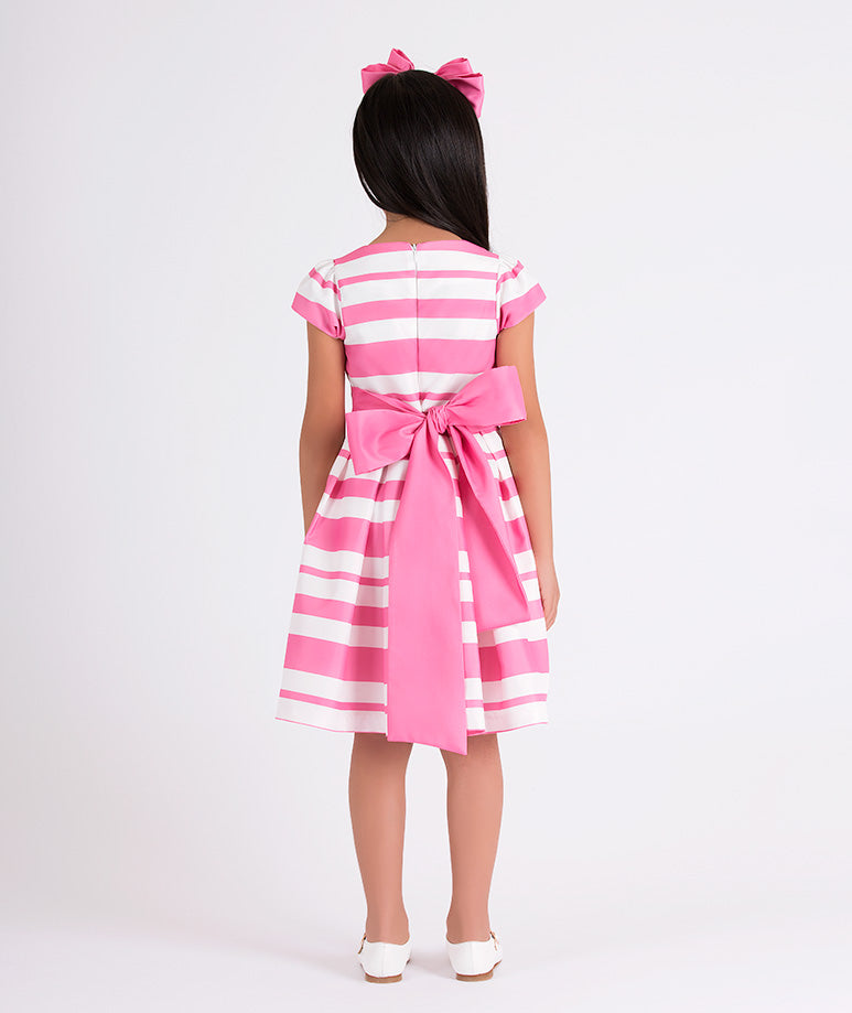 pink and white striped dress with a big pink bow on the back