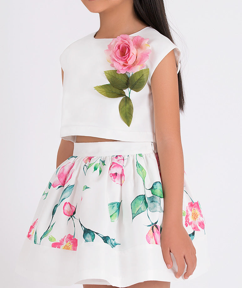 white blouse with 3D flower applique on the front and floral skirt