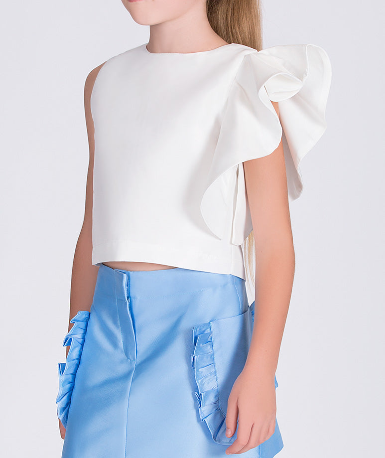 white blouse with ruffled sleeve and blue skirt with ruffled pockets