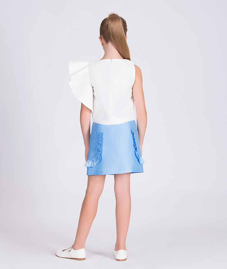 white blouse with one ruffled sleeve and blue skirt