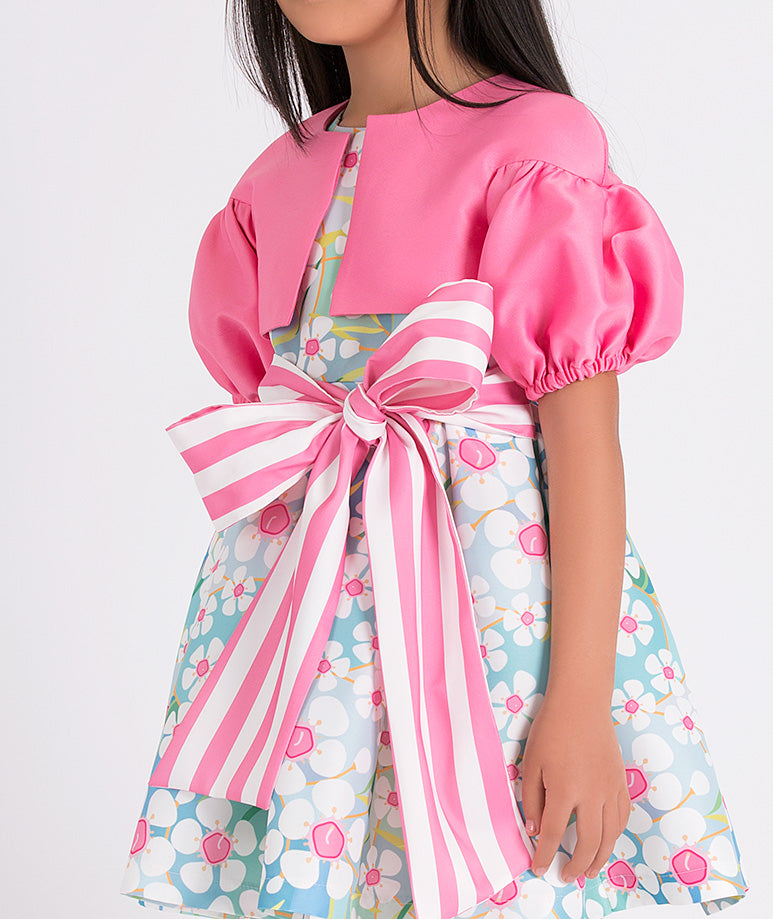 pink balloon sleeved bolero and a blue floral dress with a big pink and white striped bow on the waist