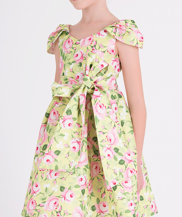 green floral dress with a bow on the waist