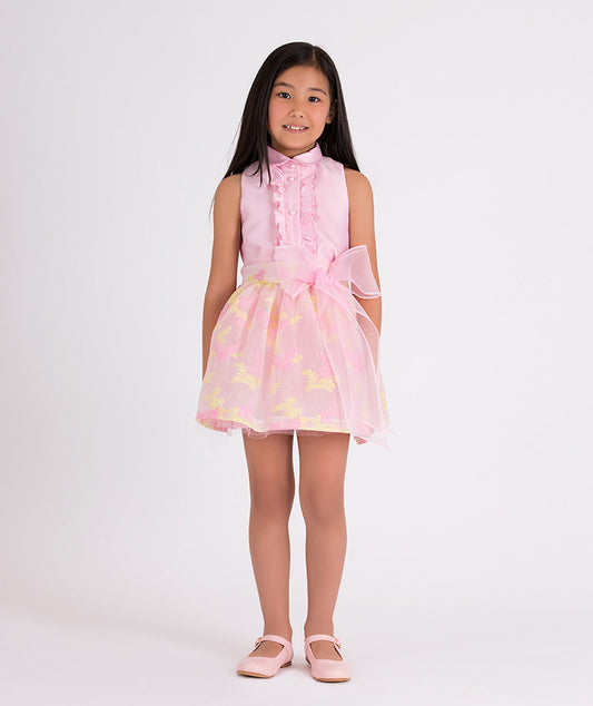 pink blouse with ruffled front and floral organza skirt with a big bow on the waist