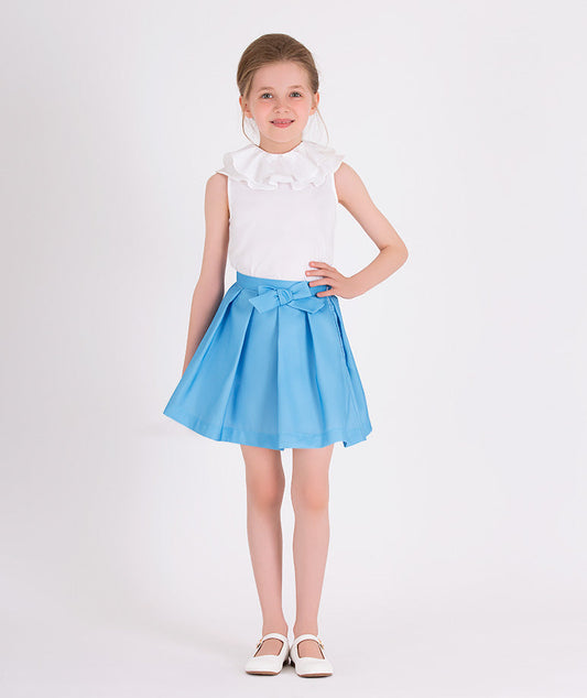 white blouse with ruffled neckline and blue skirt