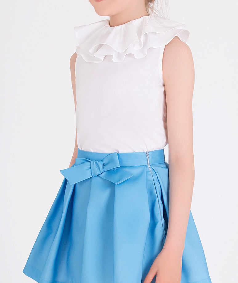 white blouse with ruffled neckline and blue skirt