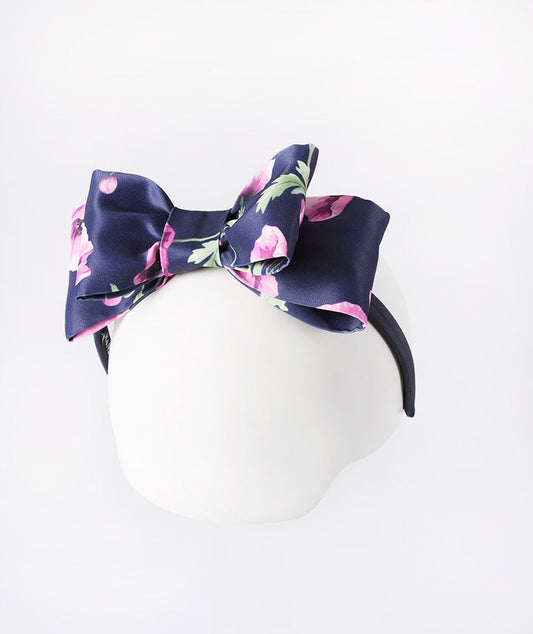 Navy headband sprinkled with delicate purple orchids—a subtle pop of floral charm.