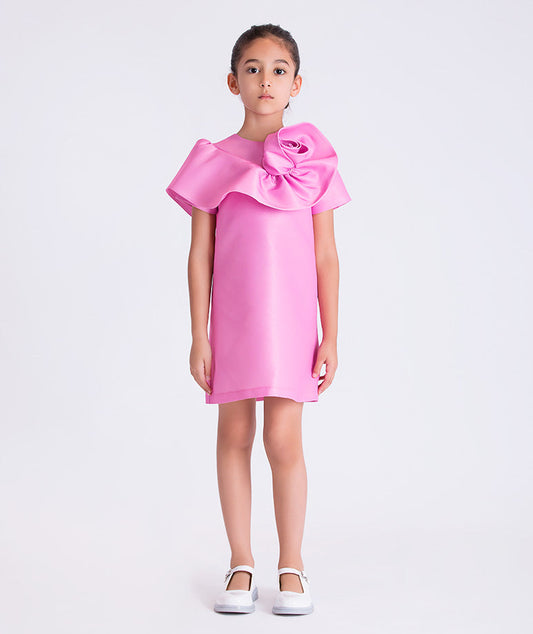 Pink luxury girls occasion dress with sculptural 3D flower shoulder detail and clean silhouette for special events