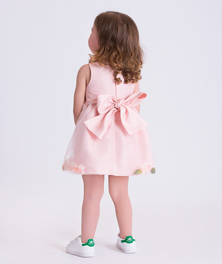 Back view of the 3D Petals Baby Girl Dress showing the oversized bow detail and softly flared tulle skirt made from breathable lightweight fabric, designed for babies ages 12–36 months for weddings, family gatherings, and photo sessions.