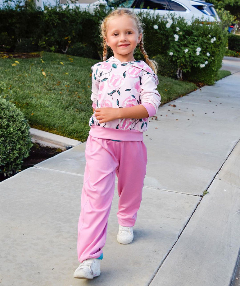Fashionable girls' pink jogger pants with a floral hoodie and blue accents