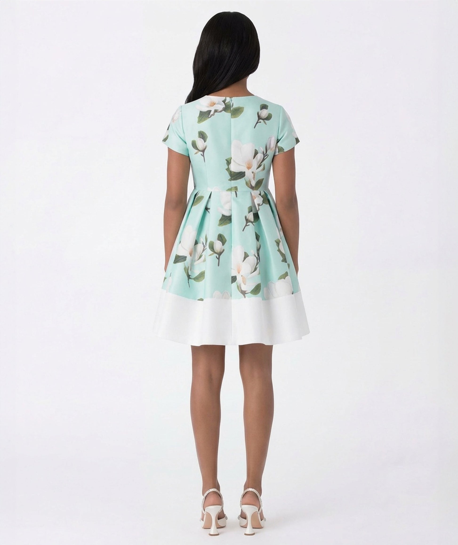 Woman wearing a floral dress with a white background