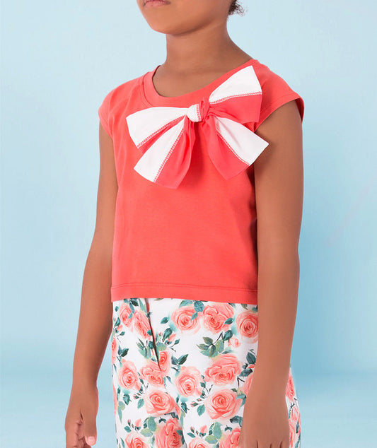A vibrant coral cotton top with a bow detail,
