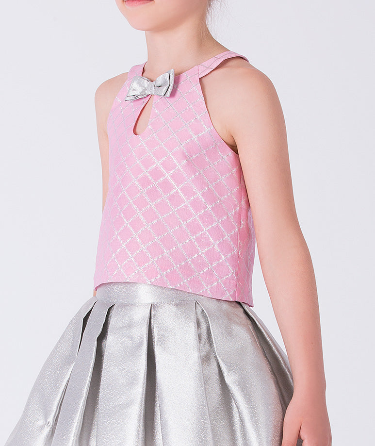 Pink top with a bow and silver skirt on a white background