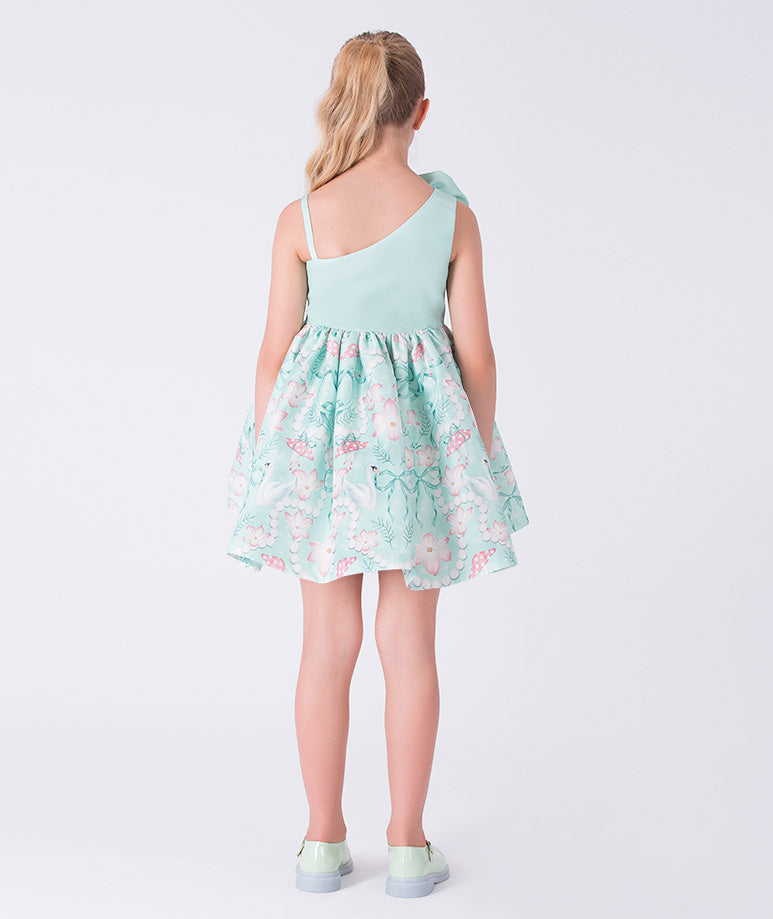 Girl wearing a light blue dress with floral pattern on a white background