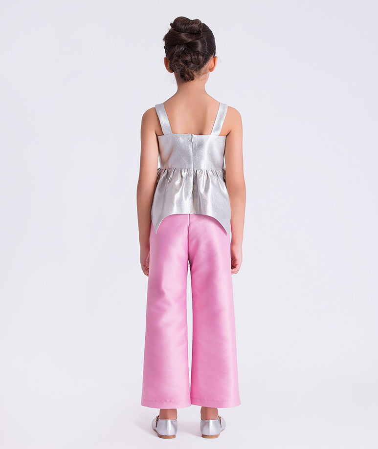 4 years old wearing a silver top and pink pants on a white background