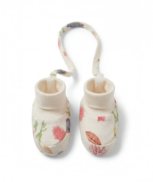 Pair of baby booties with floral design on a white background
