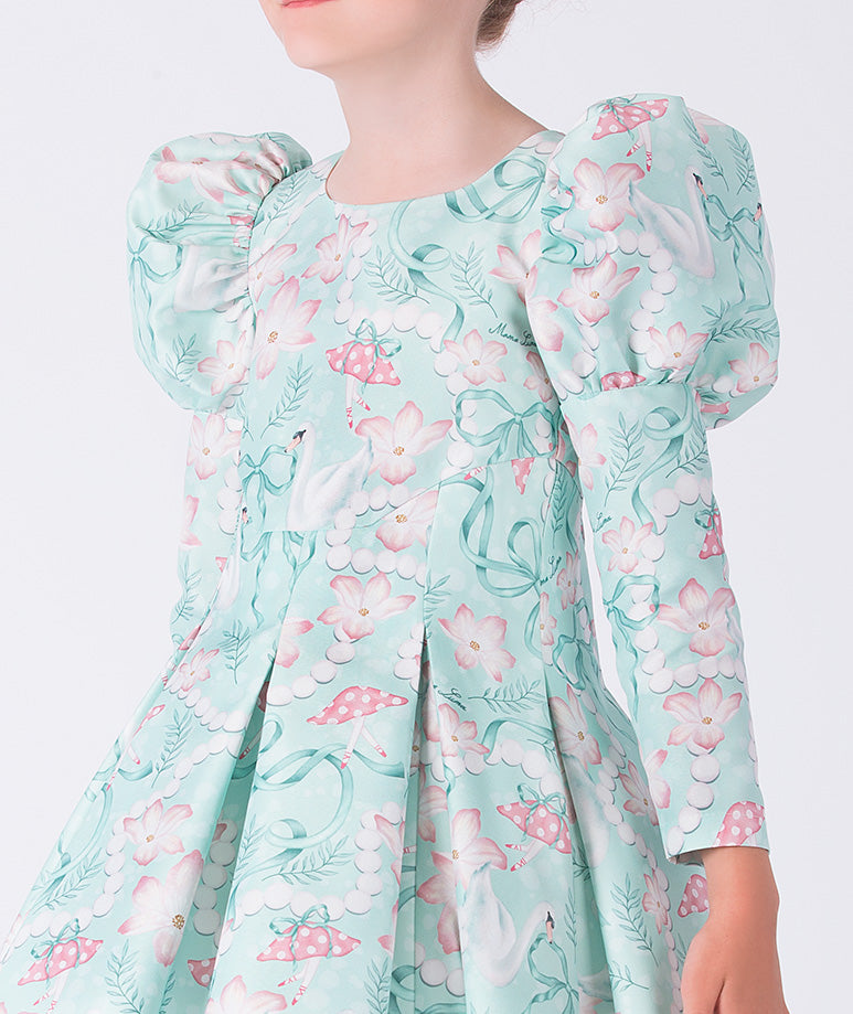 Child wearing a floral dress with puffed sleeves on a white background