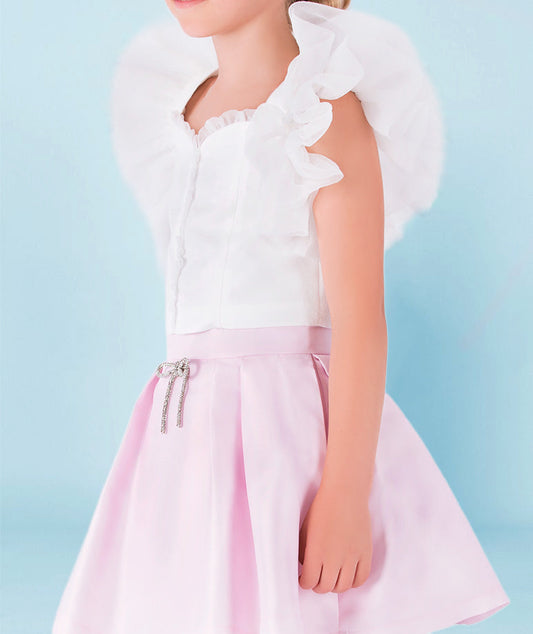 white ruffle blouse and baby pink skirt with sparkling bow