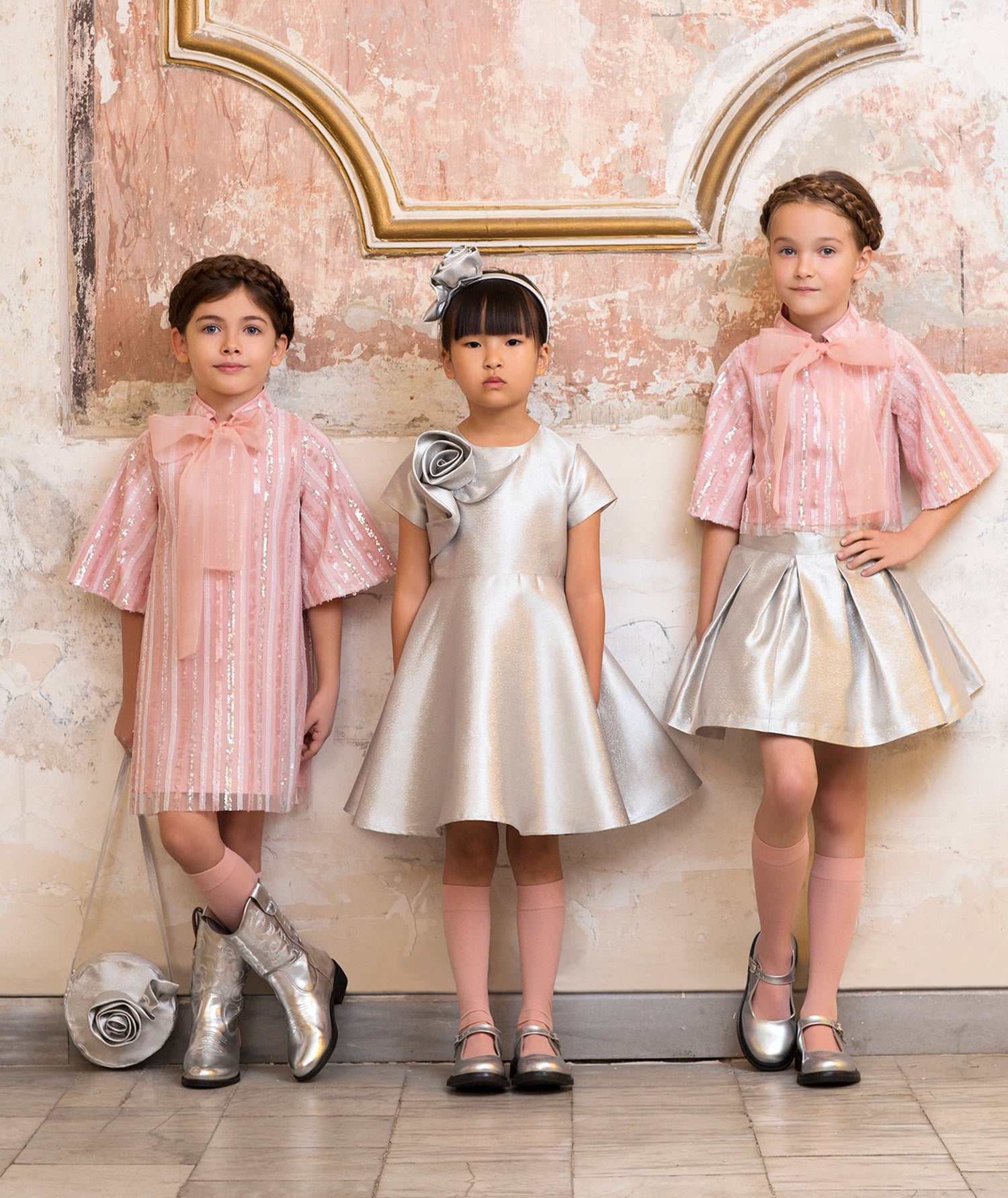 pink sparkling dress with an organza bow, silver dress with a 3D flower applique, pink sparkling blouse with an organza bow and silver skirt