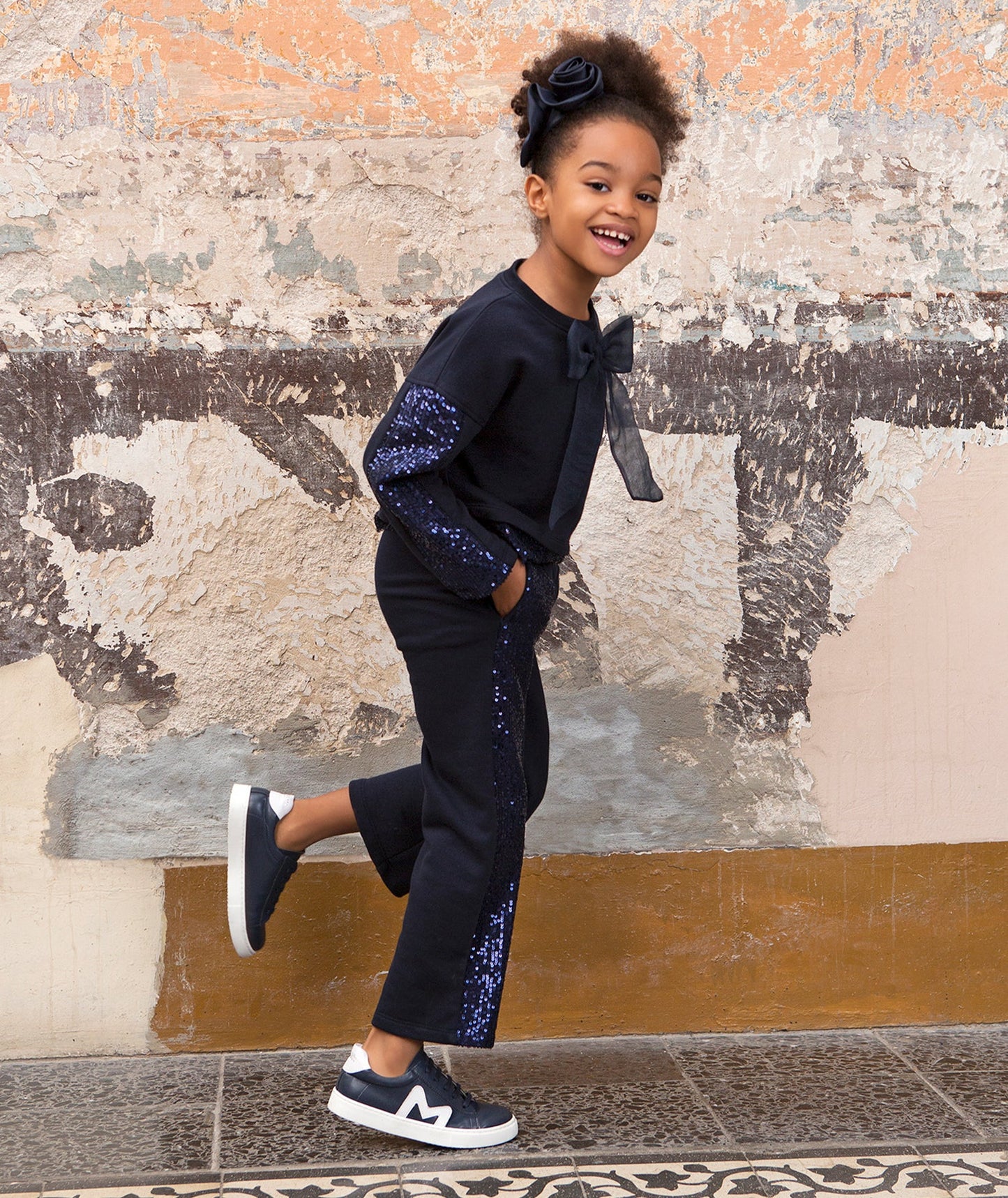 navy sparkling tracksuit with an organza bow on the front