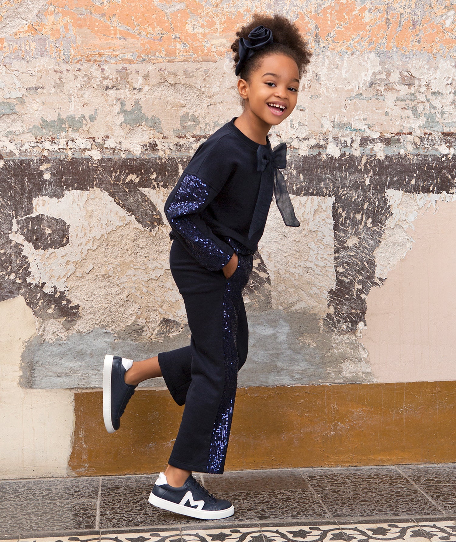 navy sparkling tracksuit with an organza bow on the front