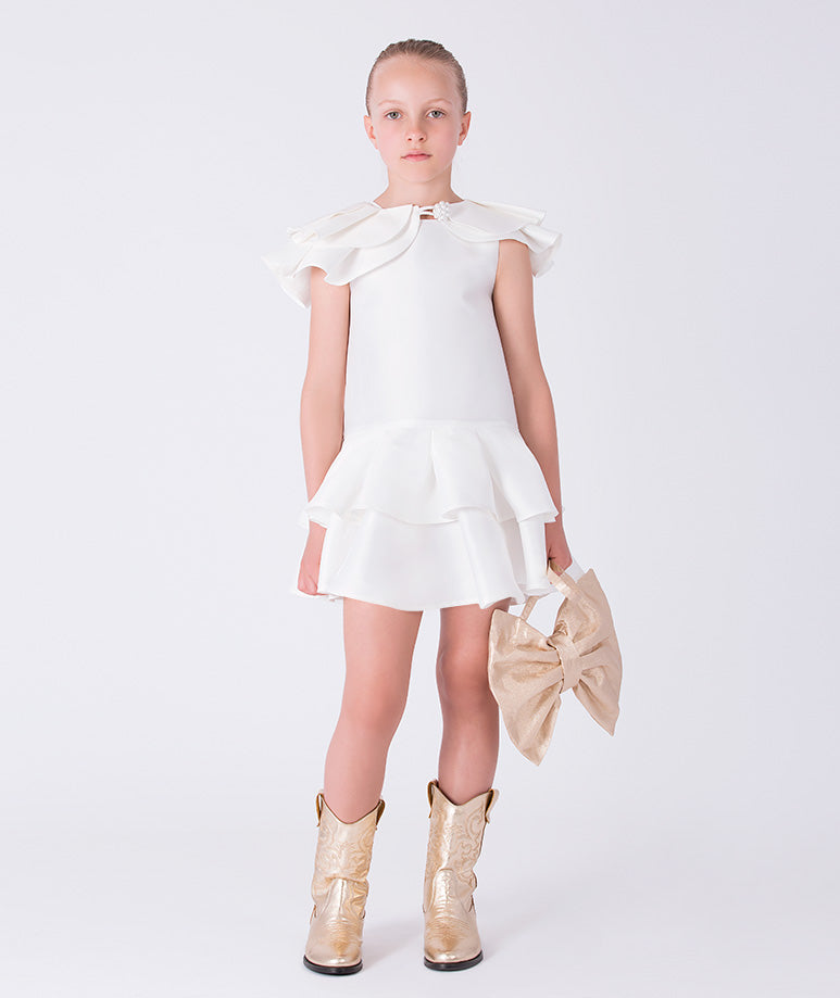 Front view of ivory girls dress with layered ruffle sleeves and tiered flounce skirt silhouette.