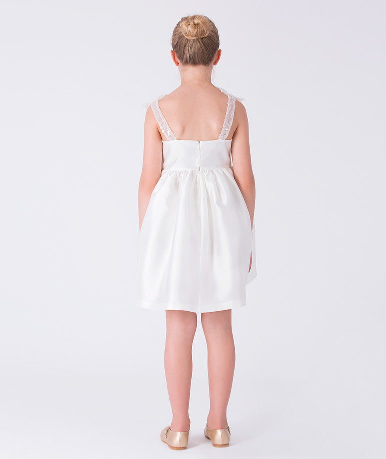 Back view of ivory girls dress featuring structured bodice, concealed zipper and softly gathered skirt.