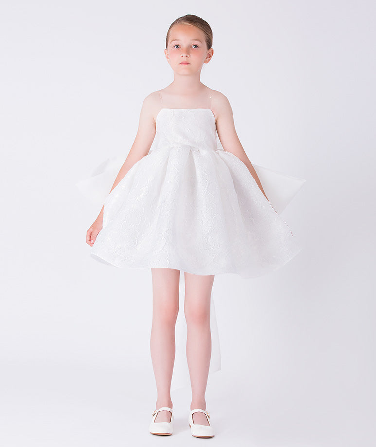 Exquisite jacquard girls occasion dress worn by a 7-year-old girl, featuring a voluminous skirt and refined silhouette for special events