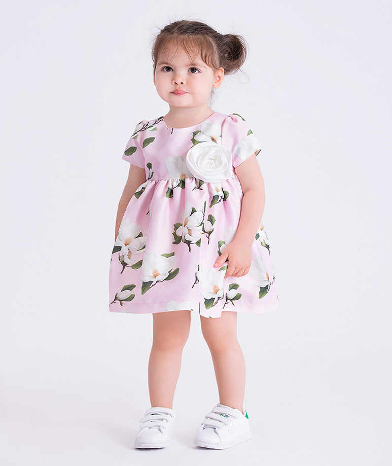 Pink floral baby dress featuring a 3D flower appliqué, by Mama Luma