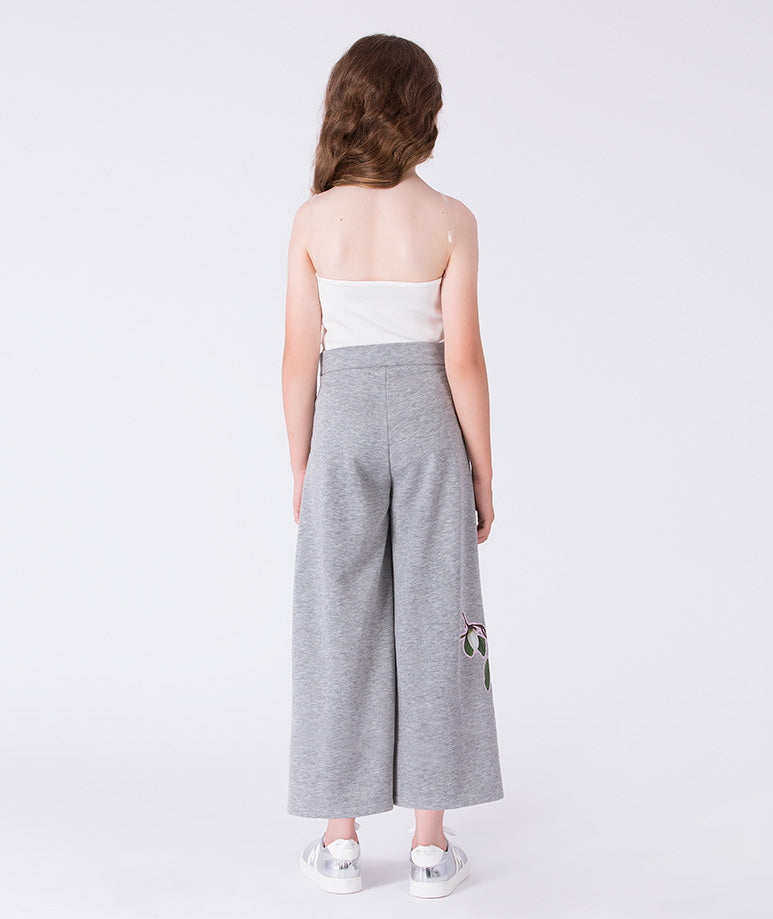 Back view of floral strapless wide-leg girls outfit by Mama Luma, elegant two-piece occasion set with wide pants