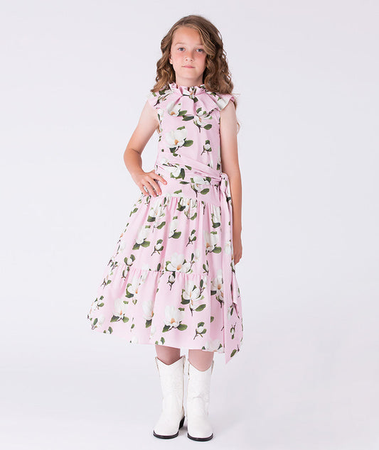 Girls floral sleeveless dress by Mama Luma featuring a ruffle neckline, tiered skirt, and waist tie, suitable for birthdays and special occasions, sizes 3–12.