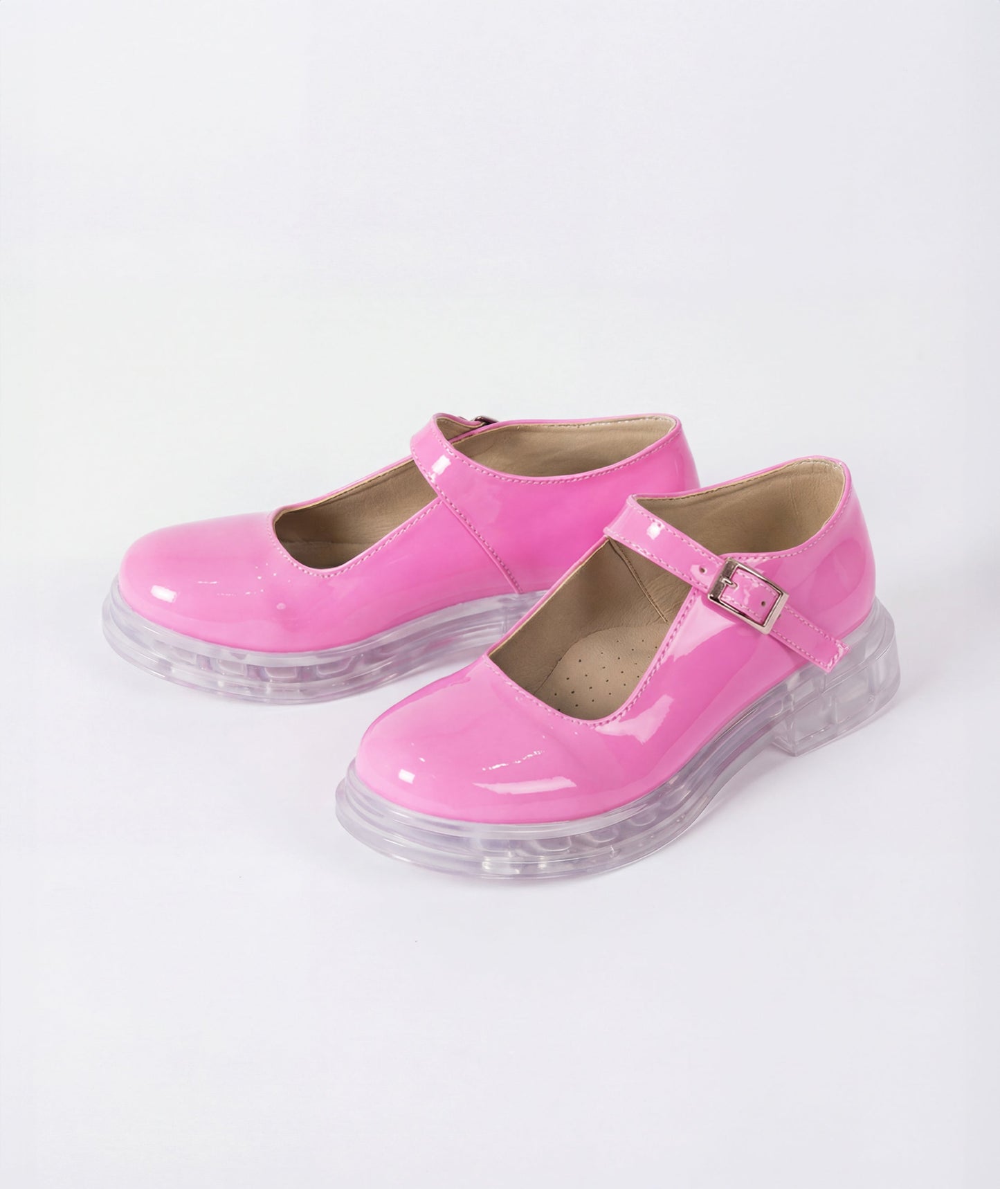 Pink shoes with clear soles on a white background