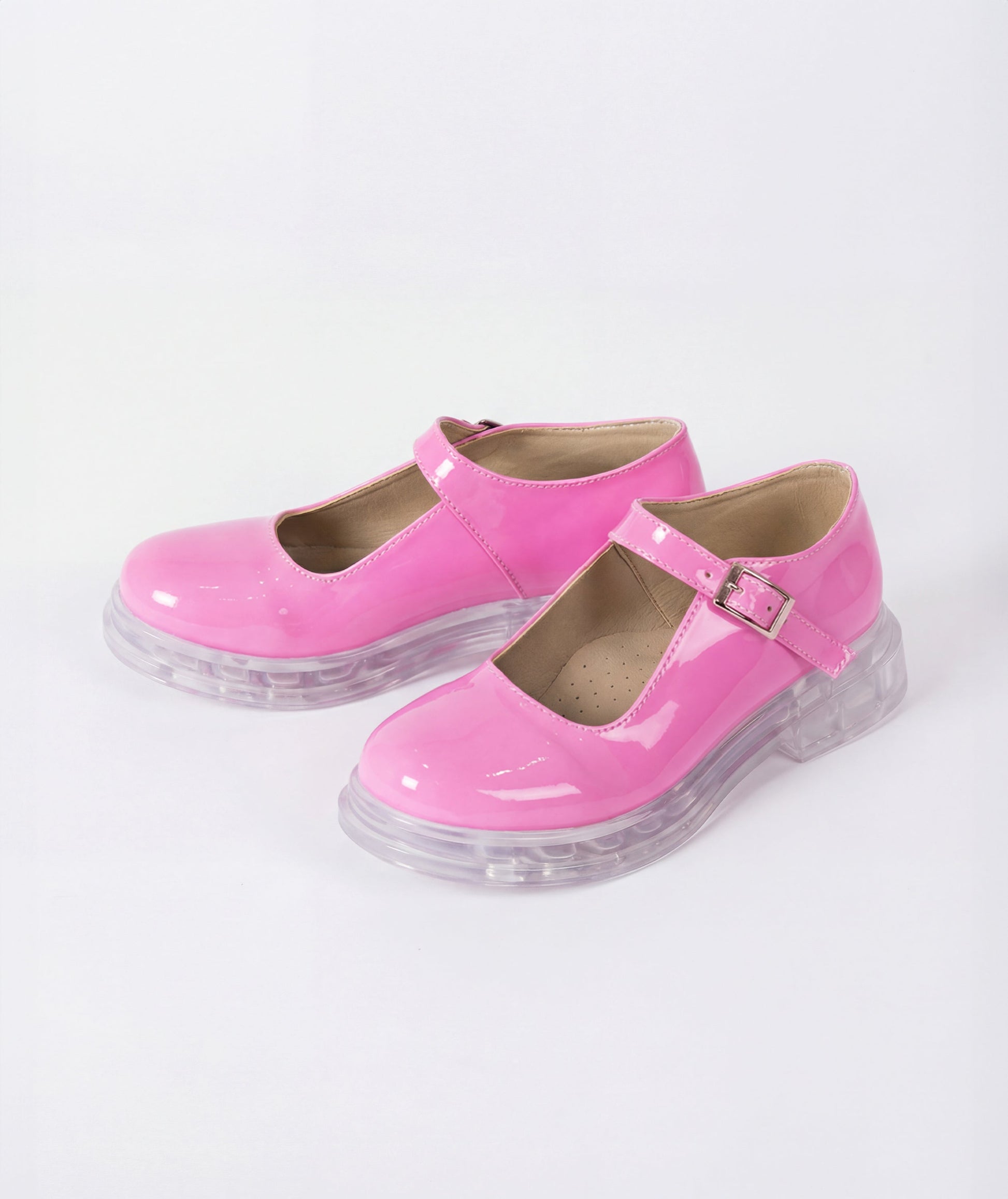 Pink shoes with clear soles on a white background