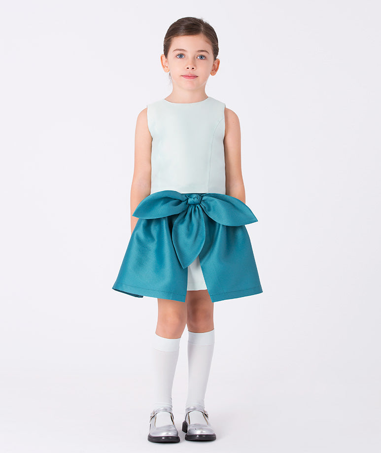 Front view of an ivory sleeveless girls blouse with a clean, structured silhouette in matte satin for formal occasions (3–12y)