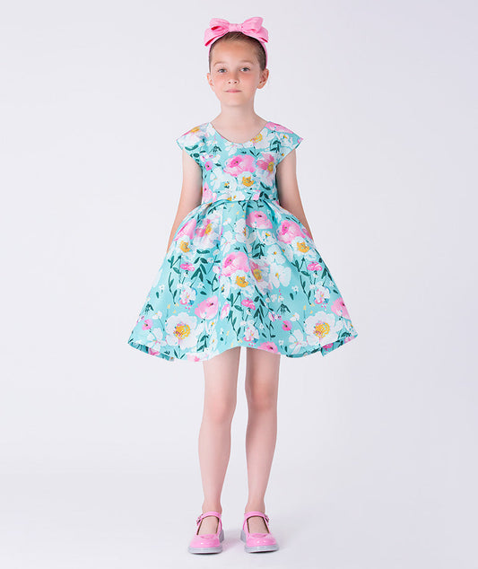 Kohana Petals Girls Dress with pastel floral print, cap sleeves, and flared skirt, front view girls occasion dress from Kohana Collection.