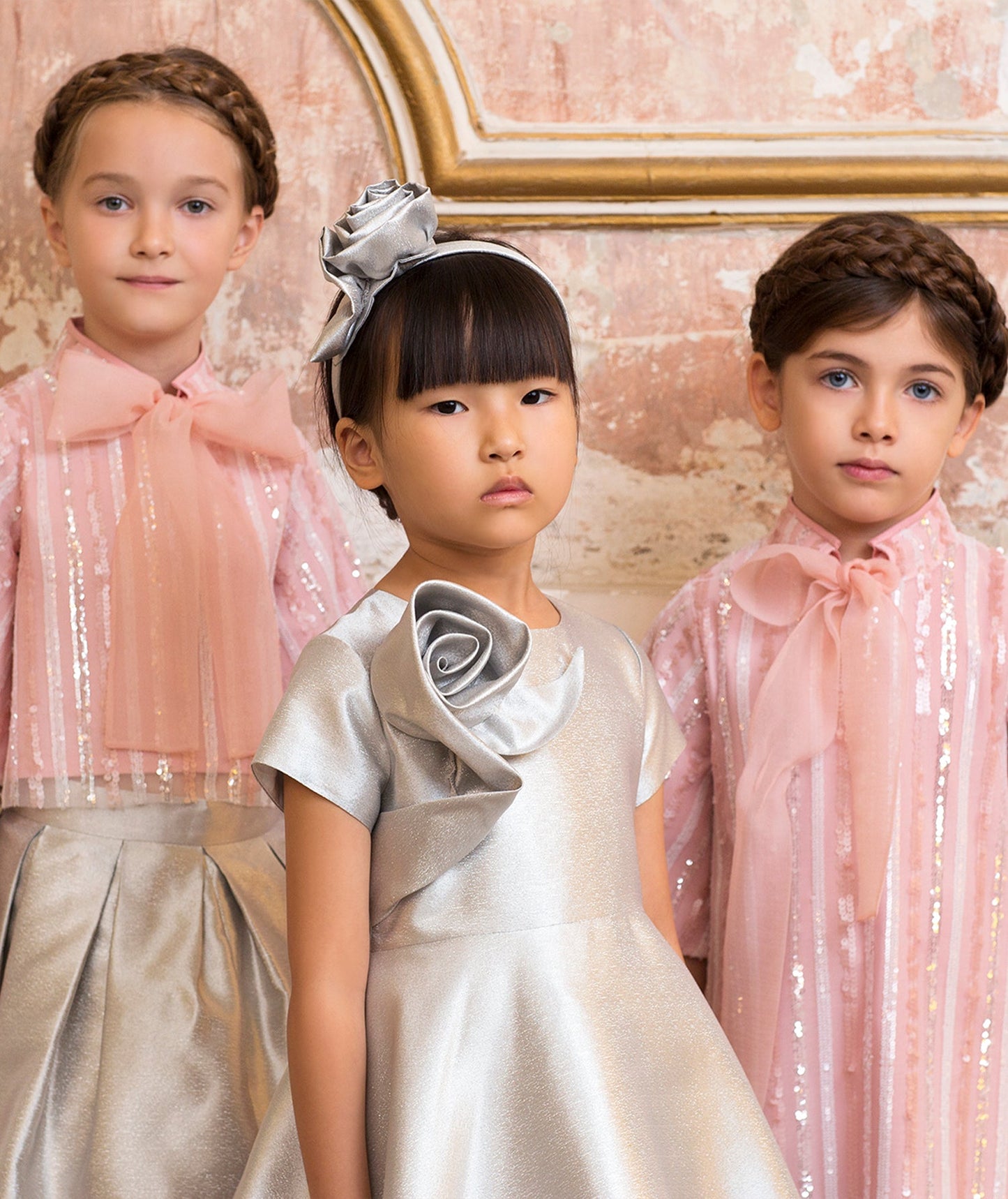 pink sparkling dress with an organza bow, silver dress with a 3D flower applique, pink sparkling blouse with an organza bow and silver skirt