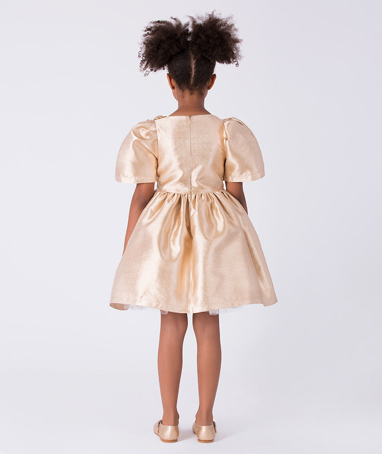 Back view of gold girls occasion dress with structured silhouette and gathered skirt from Golden Amara collection.