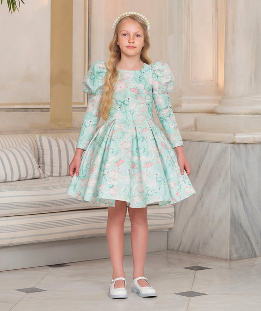 8 YEARS OLD girl in a floral dress standing in an elegant interior setting.
