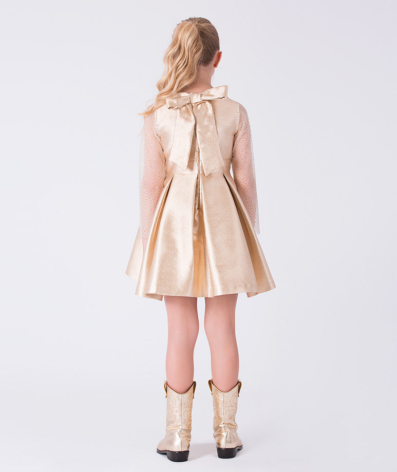 Back view of gold girls dress featuring pleated skirt, sheer sleeves and bow detail from Golden Amara collection.